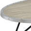 Table basse ovale de style industriel avec finition en chêne gris patiné et supports en métal noir pour une grande surface