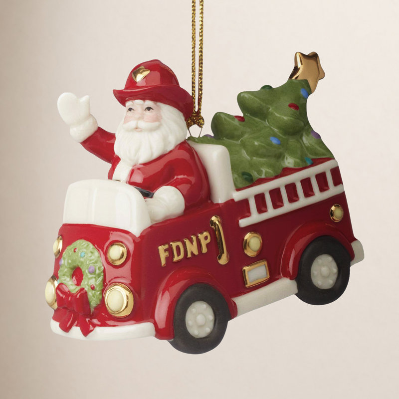 Ornement père Noël en camion de pompiers