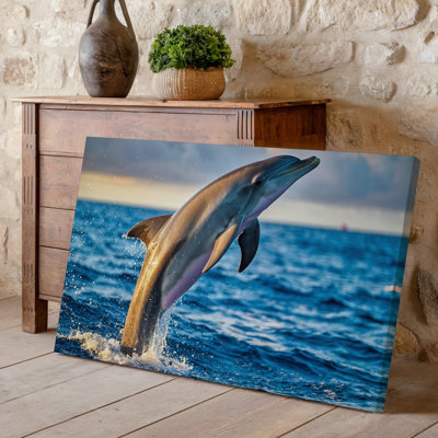 Canvas A Sleek Dolphin Gracefully Leaps Out Of A Vibrant Blue Wall Art Ocean Water Splashing Dramatically Around It Capturing A Moment Canvas Wall Art