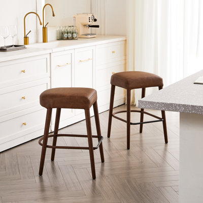 Tabouret de comptoir en faux cuir brun sans dossier avec siège rembourré confortable, fabrication en métal et repose-pieds. Idéal pour îlot de cuisine, pub, salle à manger. Conception ovale, caractéristiques ergonomiques, haute qualité