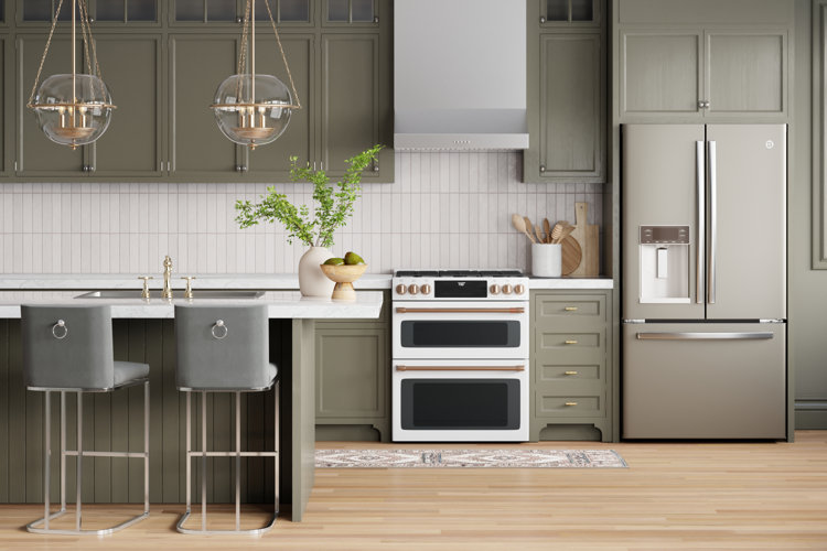 modern kitchen with gray-green cabinetry and a white range with rose-gold accents