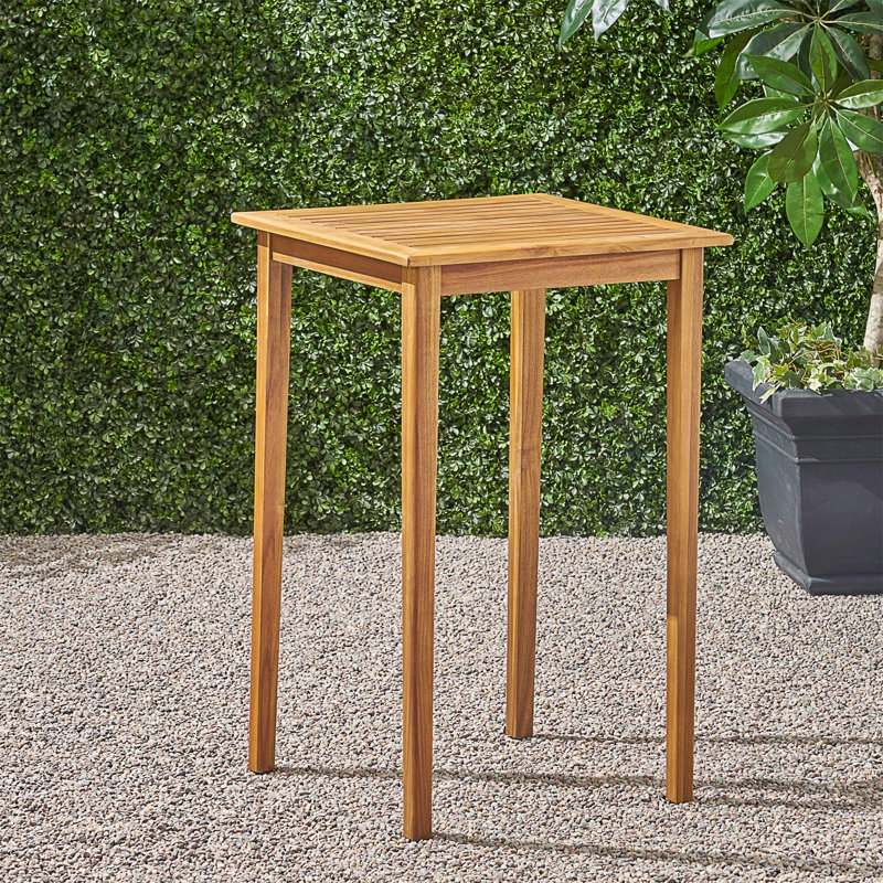 Table de bar d'extérieur carrée en bois d'acacia minimaliste avec une résistance aux intempéries et des pieds fuselés élégants