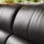 Causeuse-coussin modulable noire en cuir véritable