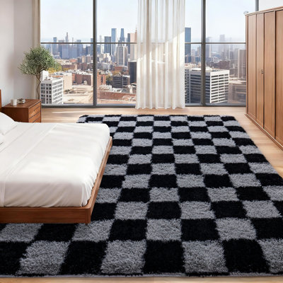 Black and gray checkered area rug with an ultra-soft, non-slip backing, suitable for living rooms, bedrooms, and nurseries.