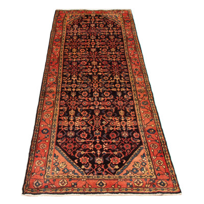 Splendid piece of work that is woven with a re-interpretation of village Persian designs. The vintage and distressed look make this hand-knotted wool rug a natural standout.