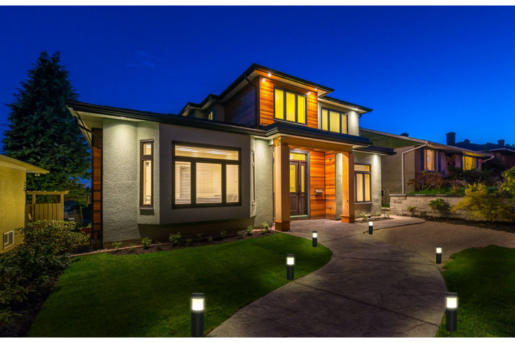 a home at dusk with bollard lights illuminating the walkway