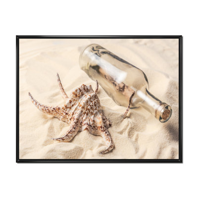 " Seashell And Bottle With Letter On Sandy Beach "