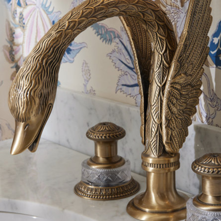 Swan faucet with ornate detail.