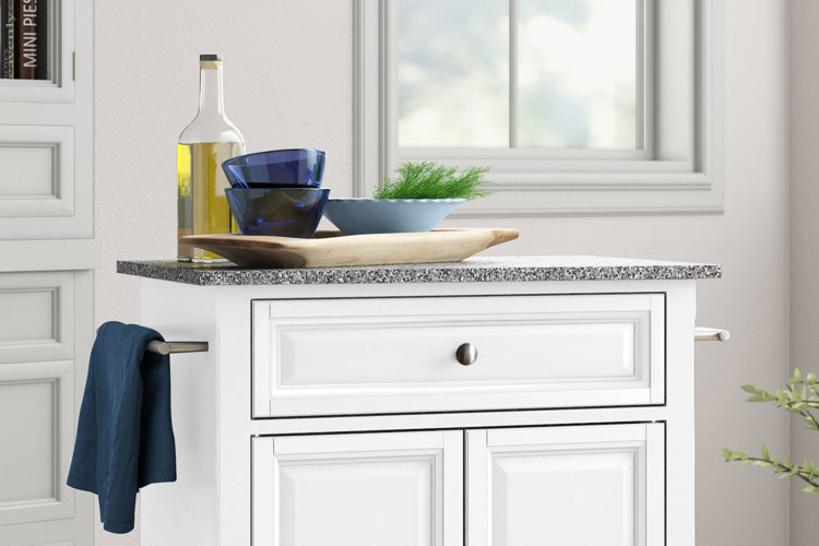 white kitchen island with a gray granite countertop