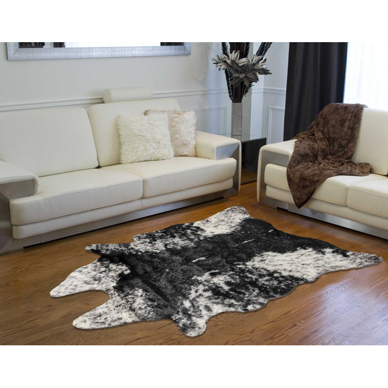 Novelty Loewen Animal Print Faux Sheepskin Area Rug in Black/White