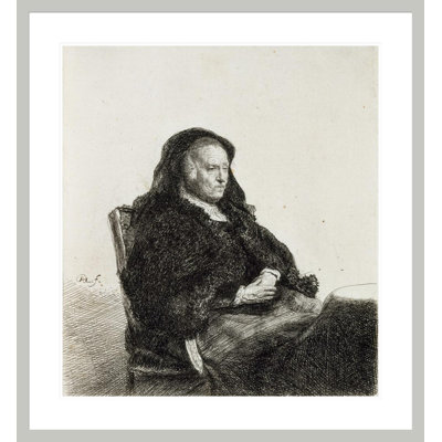 La mère de l'artiste assise à une table par Rembrandt van Rijn - Estampe numérique encadrée