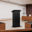 Podium en bois noir avec tablettes de rangement et trou pour câbles