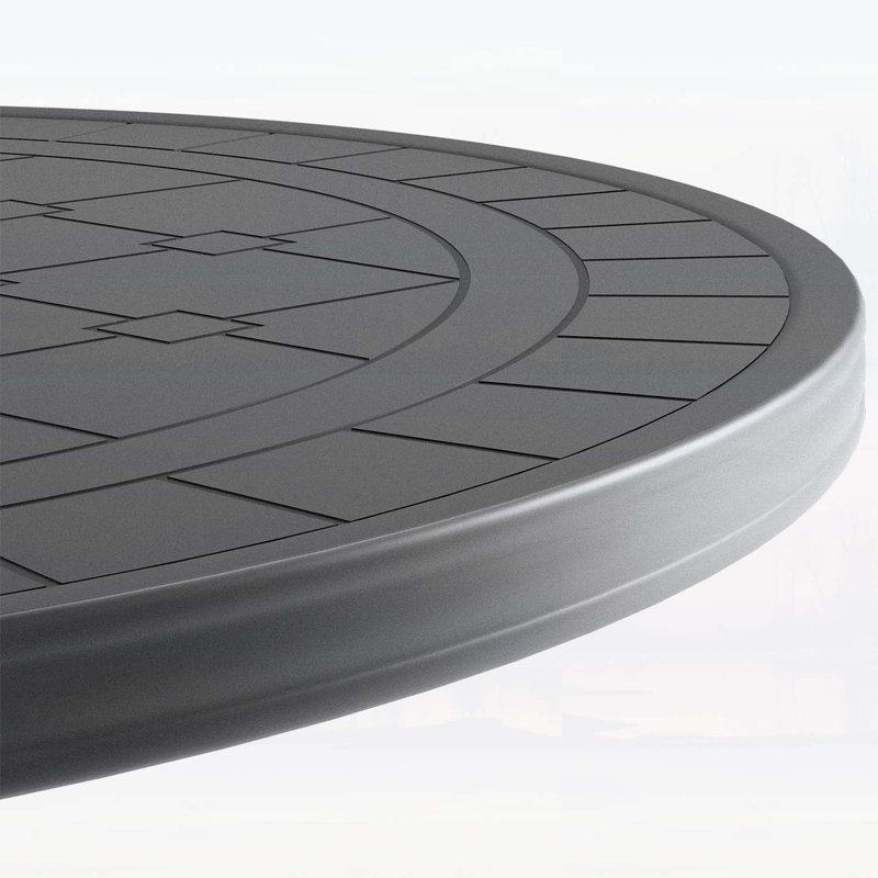 Table de salle à manger en fonte d'aluminium avec texture sculptée élégante et cadre noir résistant aux intempéries pour une utilisation extérieure