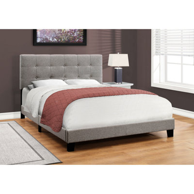 Grand lit rembourré gris avec pieds en plastique noir stable pour la taille de la chambre à coucher en gris, ce qui rehausse l'attrait