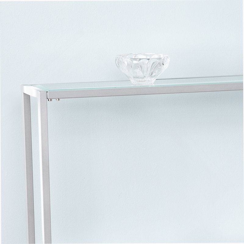 Console étroite avec finition argentée et tablettes en verre, décoration glamour et peu encombrante