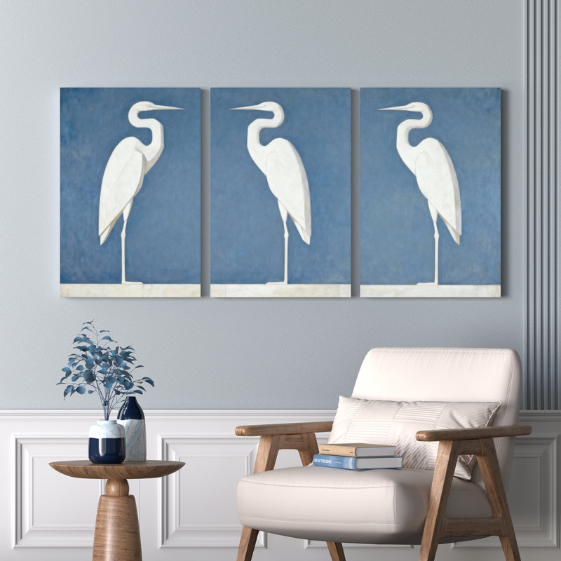 Ensemble de 3 tableaux sur toile tendue représentant un héron blanc sur fond bleu, H 18 po x l 36 po