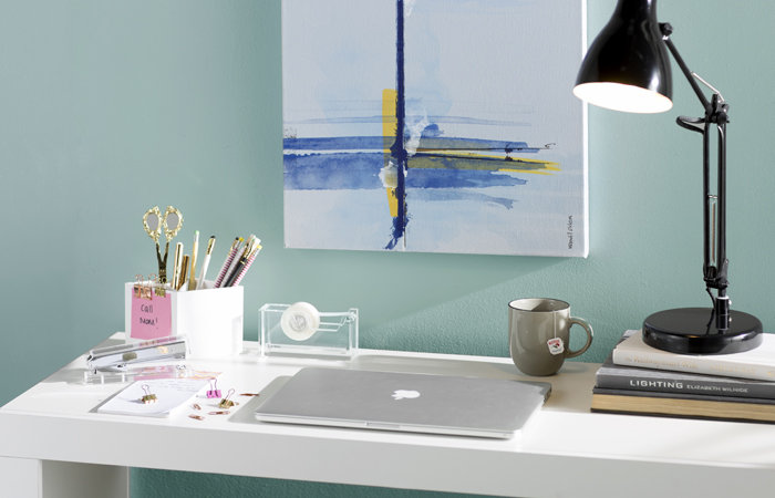 uni desk in mica with desk lamp, laptop, and beautiful wall art on canvas