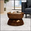 Table basse moderne en métal martelé, avec un design en forme de sablier et un dessus à rebord, pour des espaces de vie élégants.