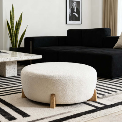 Modish Round Ottoman: Boucle Top With Splayed Rubber Wood Legs, Pumpkin Orange by Wrought Studio