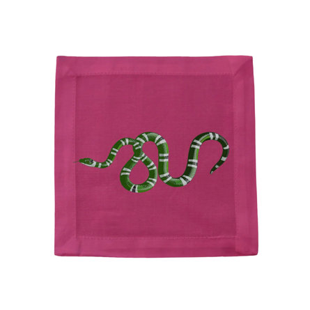 Square pink linen cocktail napkin featuring an embroidered green and white striped snake design.