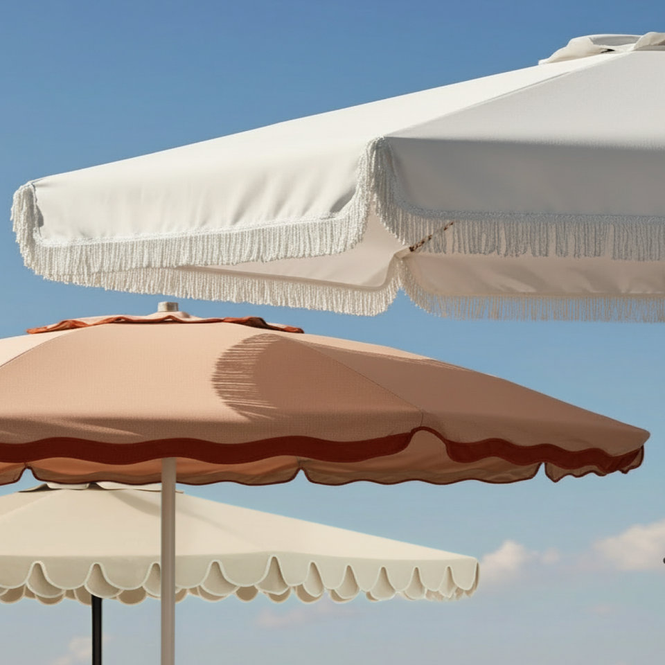 Close-up of several colorful umbrellas against a blue sky.
