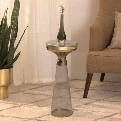 Table ronde moderne avec base en verre et plateau en métal doré