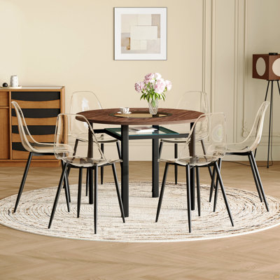 Ensemble table et chaises. Table de salle à manger ronde de 107 cm (42 pouces), style minimaliste moderne, fini bois brun. Comprend 6 chaises en plastique transparent avec pattes en métal noir. Pour un confort optimal à la maison.