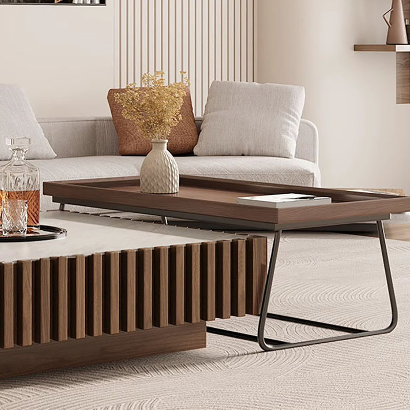 A mid-style walnut-colored coffee table set