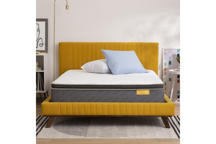 large white mattress on a beautiful yellow velvet tufted headboard and bed frame