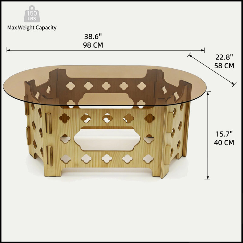 Table basse ovale de 98 cm (38,6 po) avec plateau en verre trempé caramel, piètement en bois sculpté ajouré, idéale pour une décoration moderne ou champêtre. Montage facile.