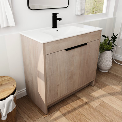 Meuble de salle de bain autoportant de 36 pouces avec lavabo. Évier en céramique blanche et 2 portes d'armoire à fermeture en douceur. Chêne clair uni. Tablette réglable. Poignées en métal. Meuble-lavabo robuste en contreplaqué autoportant.