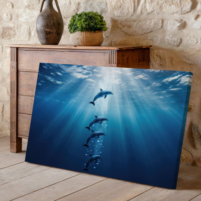 Canvas A Serene Underwater Scene Featuring Three Dolphins Gracefully Swimming Upwards Wall Art Captured In A Vertical Composition The Canvas Wall Art