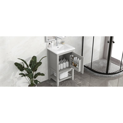 Meuble-lavabo gris avec lavabo de 50 cm, en bois massif, avec tablette de rangement et design pratique.