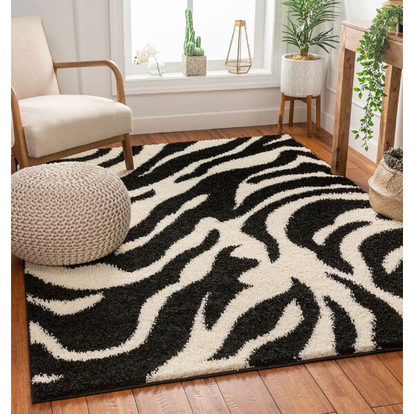 Ebern Designs Dondre Animal Print Black Area Rug & Reviews | Wayfair