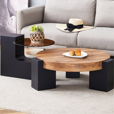 Table basse ronde à deux couches avec plateau en verre teinté transparent et pieds noirs, simples mais élégants