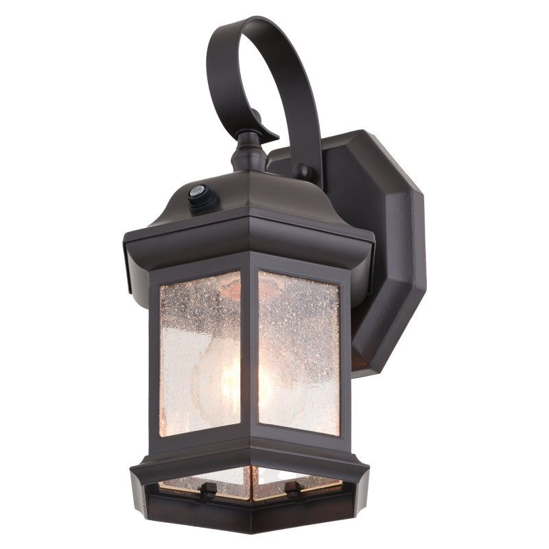 Dennishia 10.75 in. H 1-Light Medium Bronze Dusk to Dawn Sensor Outdoor Wall Sconce, Rust-Resistant Aluminum, Clear Seeded Glass Shade for Exterior Porch Patio Front Door or Garage