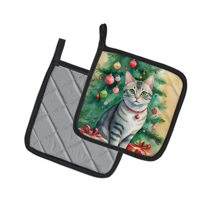 Chat asiatique par l'arbre de Noël, paire de poignées