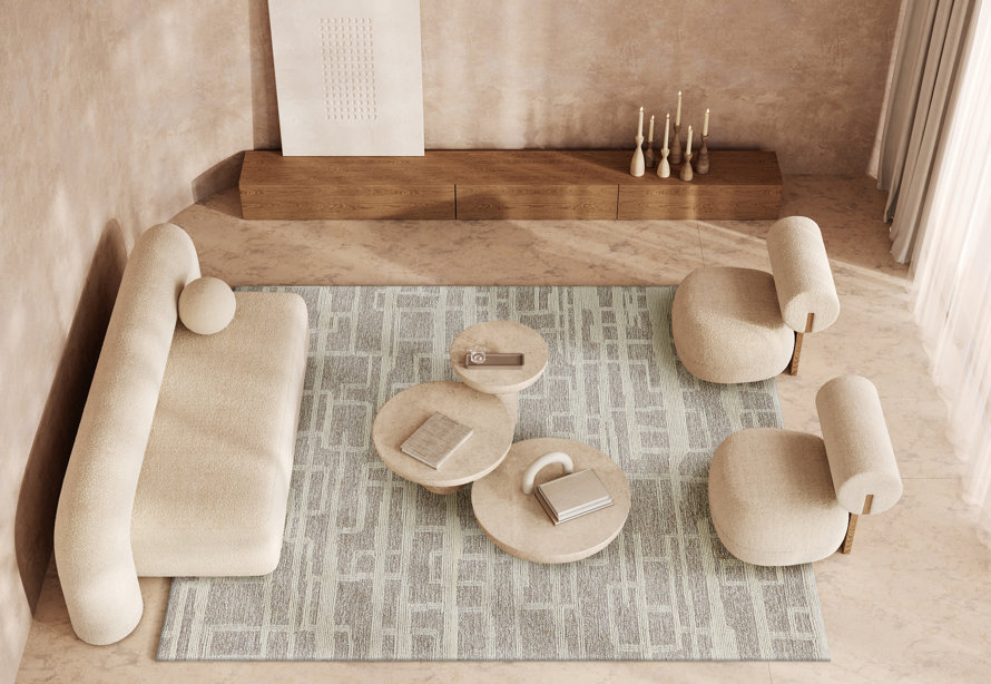 Overhead shot of living room with sofa, chairs, and layered round coffee tables.