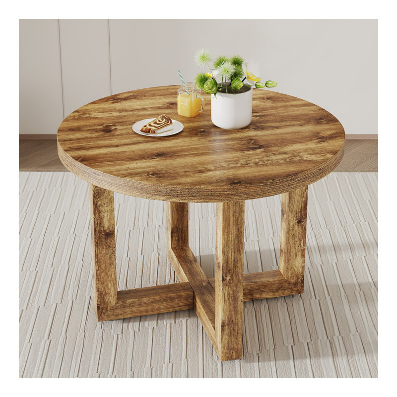 Une table de salle à manger circulaire moderne et pratique. Fabriqué en bois aggloméré et en bois. Convient au salon et à la chambre à coucher.