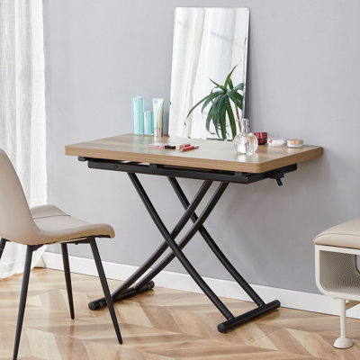 Cette table élévatrice multifonctionnelle moderne et minimaliste avec un bureau en panneau de fibres à densité moyenne de 0,8 pouce d'épaisseur et des pieds en métal noir peut être utilisée comme coiffeuse, table basse, table de salle à manger et table de bureau.