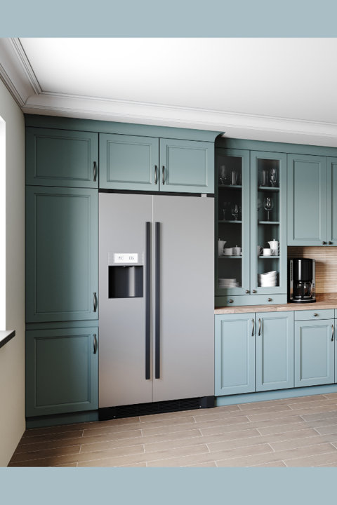 A stainless steel side-by-side refrigerator integrated into teal blue kitchen cabinetry with glass-front display cabinets and wooden countertops.