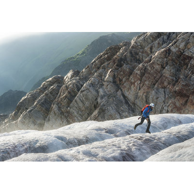 Male Hiker Jumps Across An Icy Crevasse by Wanderluster