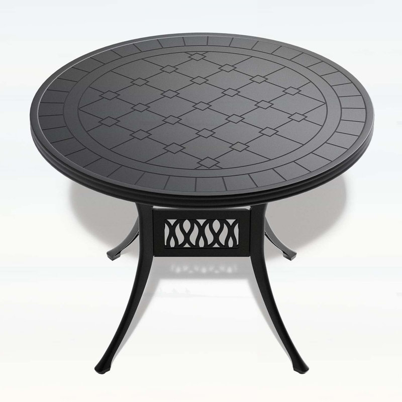 Table de salle à manger élégante en fonte d'aluminium avec une texture sculptée exquise et une finition résistante aux intempéries, parfaite pour les rassemblements en plein air