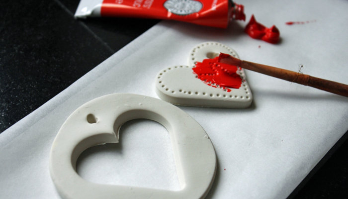 Hearts made out of white clay being painted red