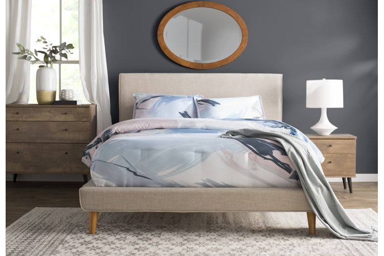 modern bed with pastel bed covers