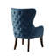 Fauteuil à finition capitonnée avec capitonnage bleu et accoudoirs à oreilles