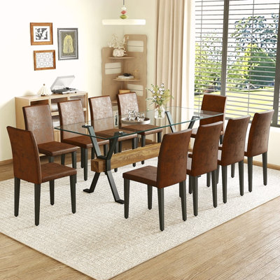 Ensemble de table et de chaises. Plateau de table en verre trempé de 79 po x 31,5 po avec pieds en métal noir en forme de X, traverse en panneau de fibres à densité moyenne à grain de bois texturé.
