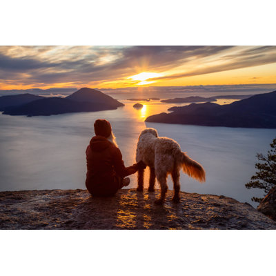 Adventurous Girl Hiking On Top Of A Mountain With A Dog by Edb3_16 - Wrapped Canvas Print