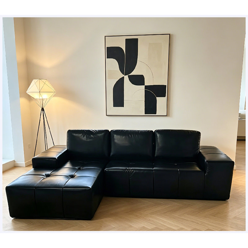 Canapé d'angle modulaire Cloud en similicuir noir, orientation gauche, avec méridienne et assise profonde.