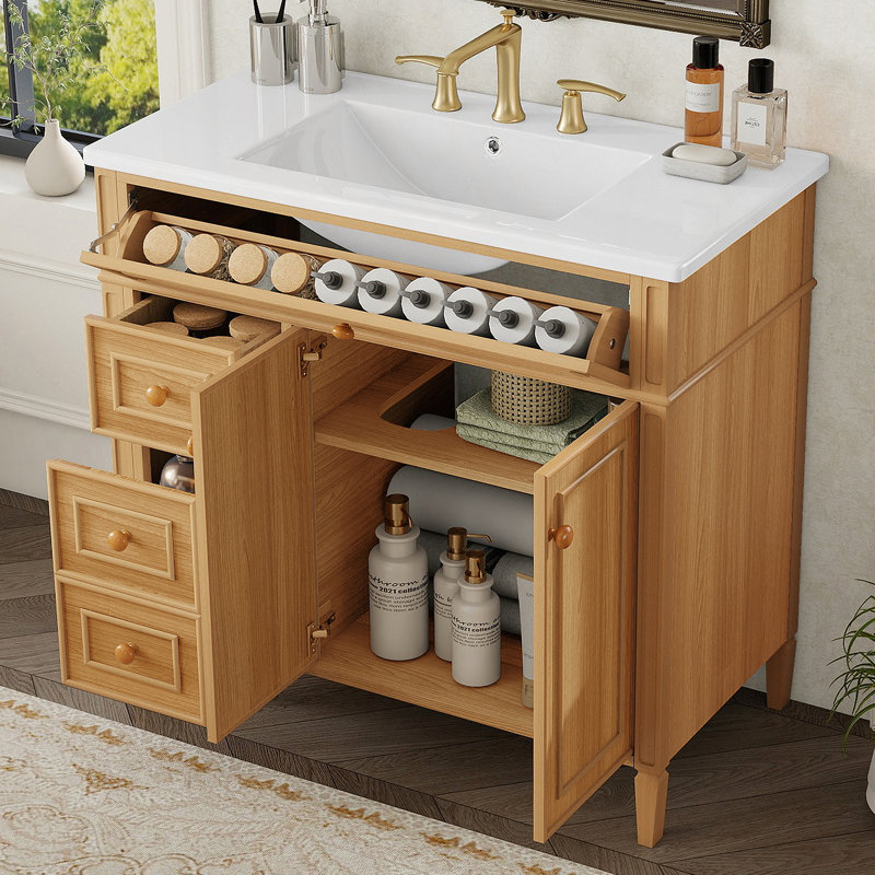 Meuble-lavabo de salle de bain avec lavabo, armoire en bois avec tiroir rabattable, plusieurs options de rangement, portes à fermeture en douceur et poignées élégantes pour les salles de bain modernes